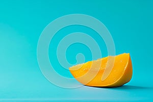 A slice of mango in isolated background - light blue background