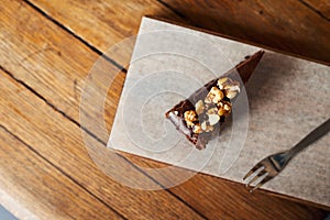 Slice of nutty chocolate cake sitting on a cafe table