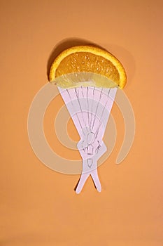 a slice of orange as a parachute for a drawn man