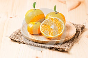 Slice orange fruit on wood plate
