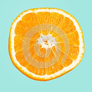 A slice of orange isolated on blue background