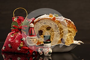 A slice of panettone next to Christmas ornaments