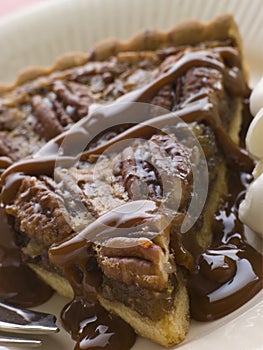 Slice Of Pecan Pie With Caramel Sauce And A Fork