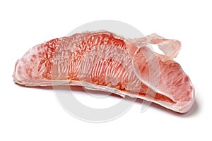 Slice of a peeled fresh red Pomelo on white background close up