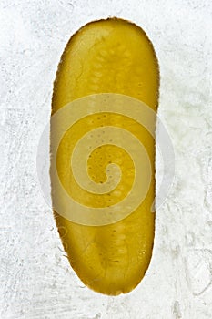 A slice of pickle frozen in ice