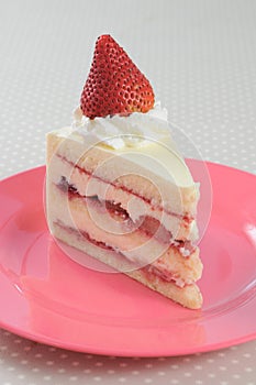 Slice piece of Strawberry shortcake on pink dish