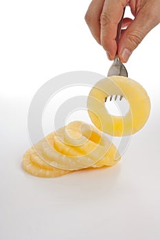 Slice of pineapple on a fork