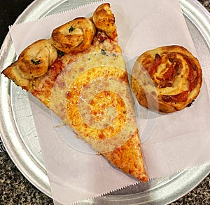 Slice of Pizza and Pastry on Plate with garlic knot crust