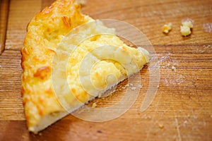 Slice of pizza on the wooden desk