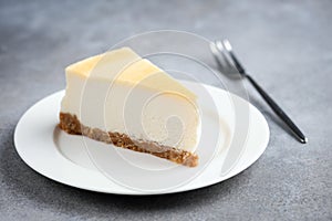 Slice of plain cheesecake on white plate