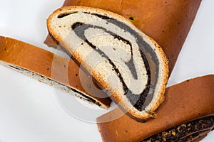 Slice of poppy seed roll on other parts of roll