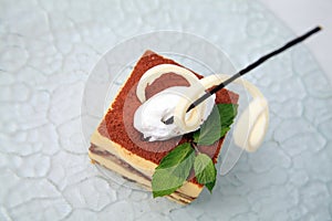 Slice portion of tiramisu cake pastry sweet dessert on glass plate