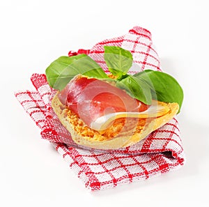 Slice of prosciutto on crispy bread