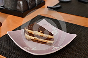 A slice of puff chocolate cake in a cafe