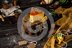 Slice of pumpkin cheesecake with caramel sauce and seeds on top