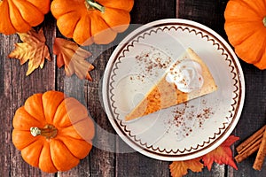 Slice of pumpkin cheesecake, overhead table scene