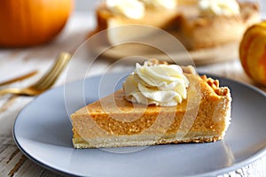 Slice of pumpkin pie on a plate. Selective focus.