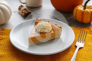 Slice of pumpkin pie on a plate. Selective focus.