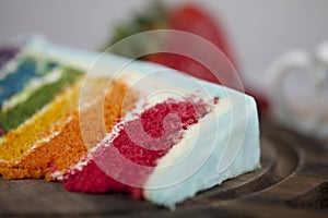 A Slice of Rainbow Cake with some Strawberries and Cup of Coffee