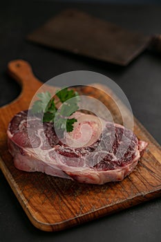 Slice of raw beef shank on a cutting board