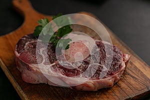 Slice of raw beef shank on a cutting board