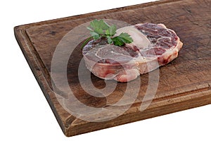Slice of raw beef shank on a cutting board