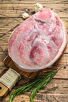 Slice of raw pork knuckle, leg. Farm fresh meat. Wooden background. Top view