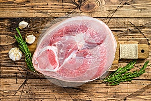 Slice of raw pork knuckle, leg. Farm fresh meat. Wooden background. Top view