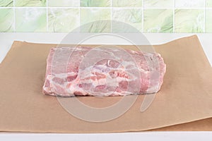 Slice raw pork meat on baking paper.