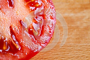 Slice of red ripe tomato