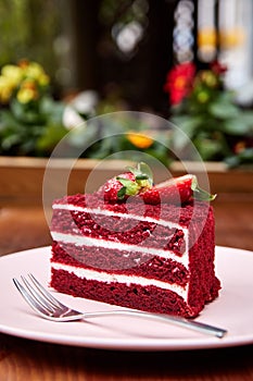 Slice of Red Velvet cake decorated with berries