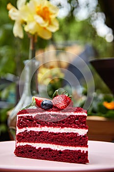 Slice of Red Velvet cake decorated with berries