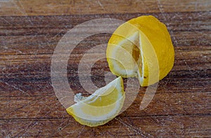 Wedge of lemon next to the fruit concept dropout photo