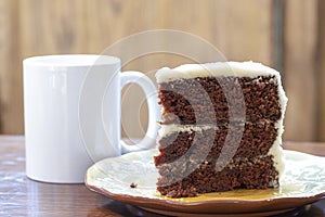 A slice of rich moist 3 layer chocolate cake on a plate