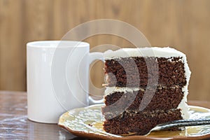 A slice of rich moist 3 layer chocolate cake on a plate