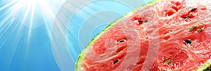 Slice of ripe, juicy watermelon on a blue background, summer refreshment under radiant sun rays. photo