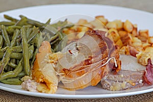 Slice of roast pork orloff and vegetables on a table