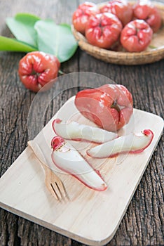 Slice rose apple on wood plate