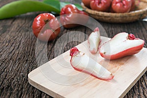 Slice rose apple on wood plate