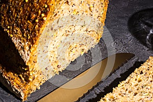 slice of rustic natural yeast-free bread with flax, poppy seeds, sesame seeds, millet, pumpkin and sunflower seeds, with