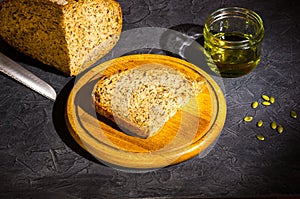 Slice of rustic natural yeast-free bread with flax, poppy seeds, sesame seeds, millet, pumpkin and sunflower seeds, with