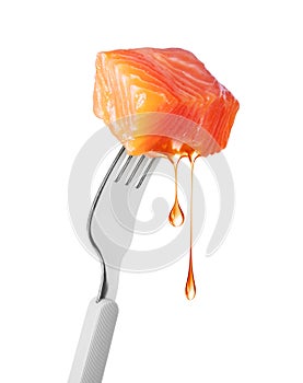 Slice of salmon with dripping drops of fat on a fork