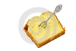 Slice of sponge cake with cake fork isolated