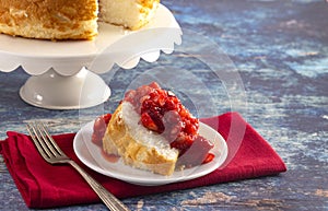 Slice of Strawberry Short Cake Made with Angel Food Cake and Strawberry Sauce