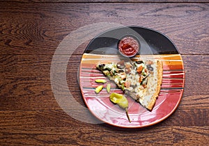 Slice of Thin Crust Fresh Spinach & Tomato Alfredo on Textured Plate photo