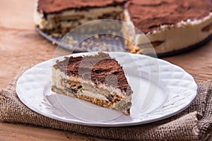 A slice of tiramisu cake served on white plate