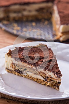 A slice of tiramisu cake served on white plate