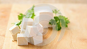 Slice tofu on wooden board preparing for cooking