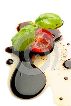 Slice tomato and basil over balsamic vinegar