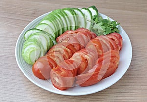 Slice Tomatoes, Cucumbers with Corianders on Dish photo